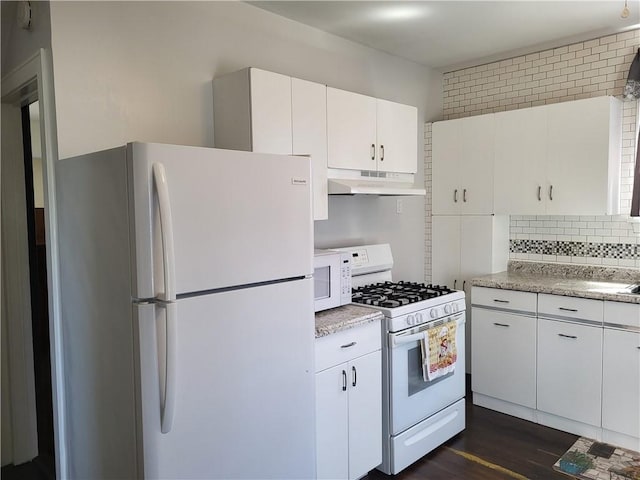 211 Oak St, City Of But Ne, PA 16001 - kitchen with white appliances, white cabinets, under cabinet range hood, decorative backsplash, and dark wood-style floors