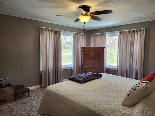 211 Oak St, City Of But Ne, PA 16001 - carpeted bedroom with baseboards, a ceiling fan, a textured wall, and a textured ceiling
