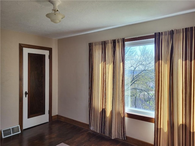 211 Oak St, City Of But Ne, PA 16001 - unfurnished room featuring baseboards, dark wood finished floors, visible vents, and plenty of natural light