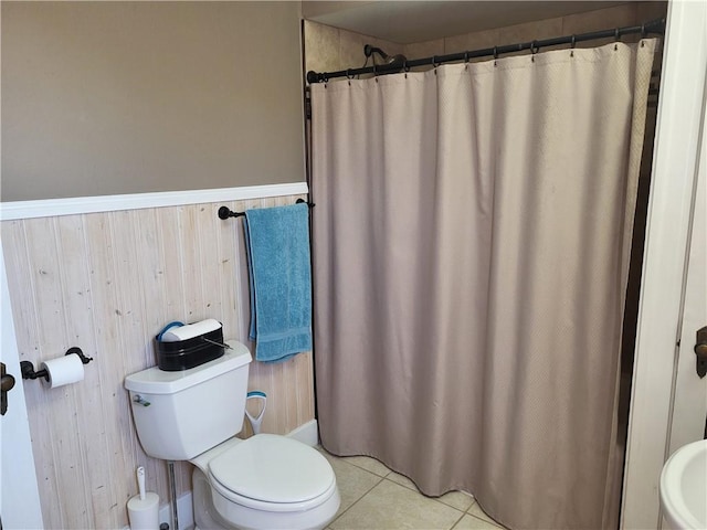 211 Oak St, City Of But Ne, PA 16001 - full bath featuring a wainscoted wall, toilet, curtained shower, tile patterned floors, and wooden walls