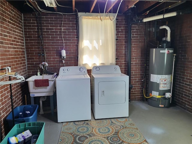 211 Oak St, City Of But Ne, PA 16001 - laundry area featuring laundry area, brick wall, washing machine and clothes dryer, and gas water heater
