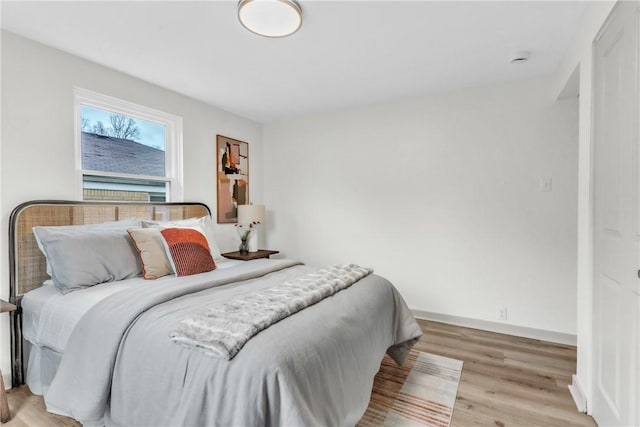 bedroom with baseboards and light wood-style floors