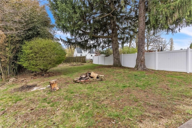 view of yard with an outdoor fire pit and fence private yard