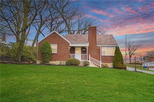 4535 Veman Ave, Whitehall, PA 15227 - view of front facade with a chimney, a front lawn, and brick siding