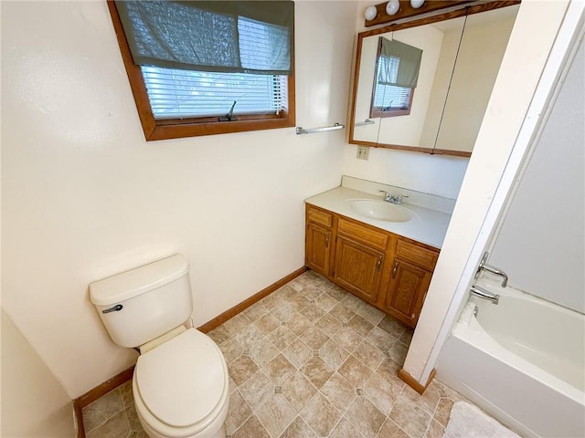 full bath featuring vanity, baseboards, and toilet