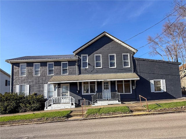 view of front of property featuring a porch and metal roof