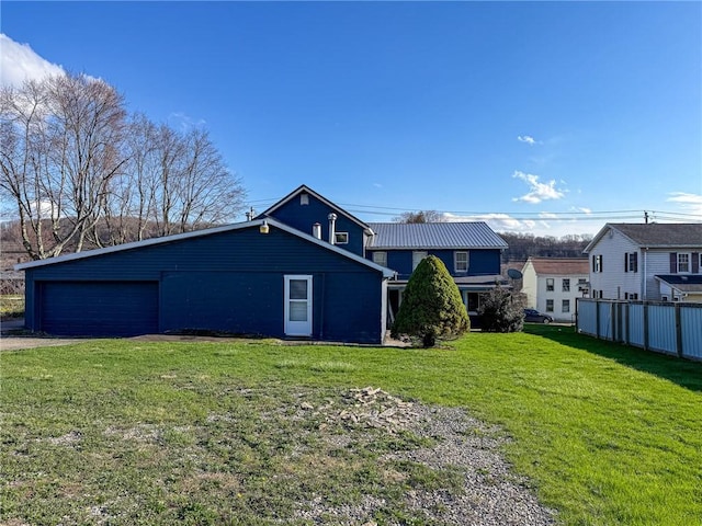 exterior space with a yard, metal roof, and fence