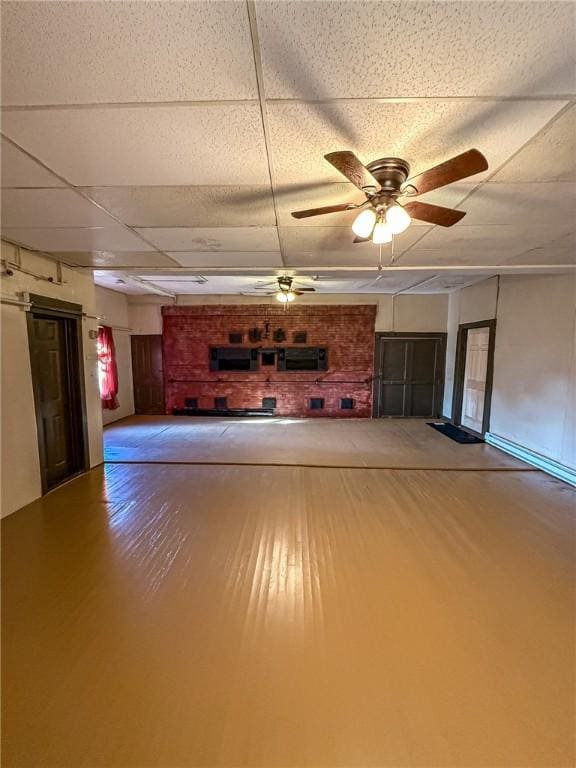 interior space featuring a paneled ceiling, a ceiling fan, and wood finished floors