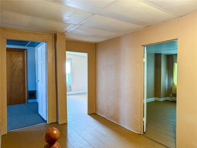 corridor with visible vents and wood finished floors