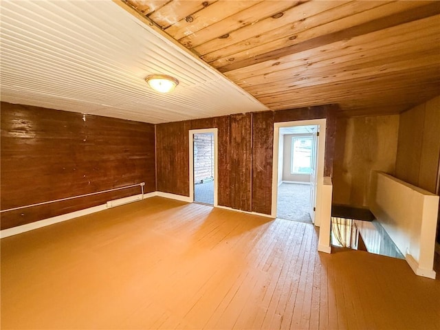 bonus room featuring hardwood / wood-style floors, wooden ceiling, and wooden walls
