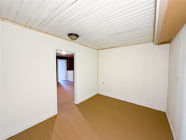 empty room with light wood finished floors and baseboards