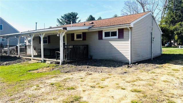 back of property featuring covered porch