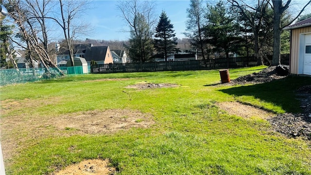 view of yard with a residential view and fence