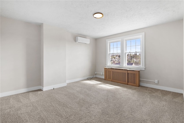 carpeted empty room with baseboards, an AC wall unit, a textured ceiling, and radiator