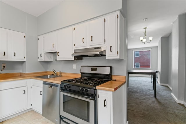 1968 Straubs Ln, Troy Hill, PA 15212 - kitchen featuring white cabinets, under cabinet range hood, stainless steel appliances, light colored carpet, and a sink
