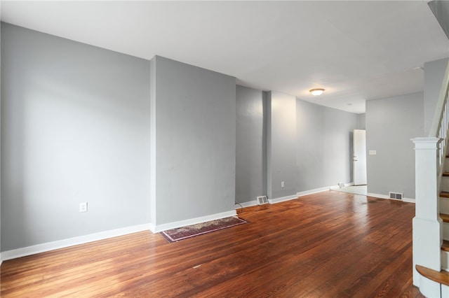1968 Straubs Ln, Troy Hill, PA 15212 - unfurnished living room with stairs, visible vents, baseboards, and wood finished floors
