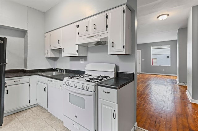 1968 Straubs Ln, Troy Hill, PA 15212 - kitchen with white appliances, dark countertops, white cabinets, under cabinet range hood, and a sink