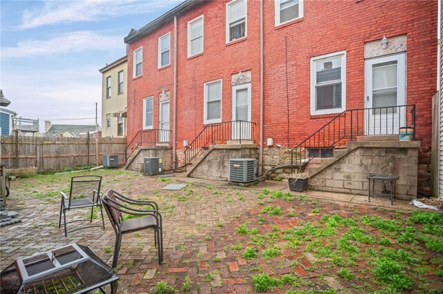 1968 Straubs Ln, Troy Hill, PA 15212 - back of property with brick siding, fence, and central air condition unit