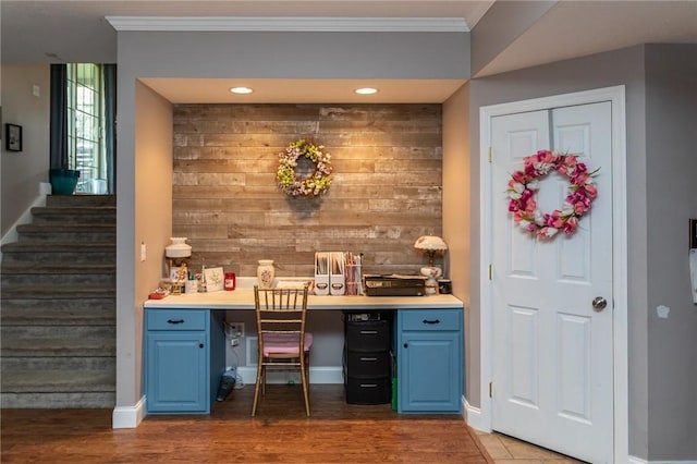 bar with baseboards, wood finished floors, stairs, and ornamental molding