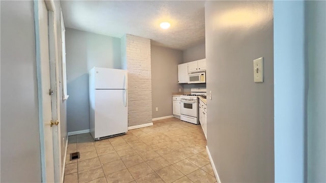 1406 Superior Ave, Brighton Heights, PA 15212 - kitchen with baseboards, white appliances, light tile patterned floors, white cabinets, and visible vents