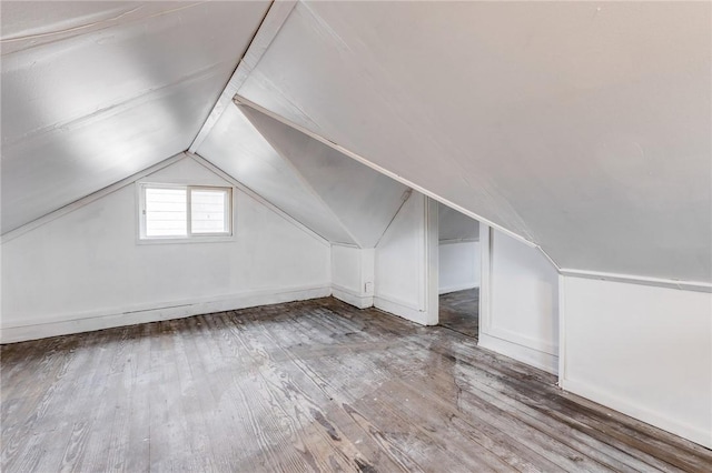 bonus room with vaulted ceiling and wood finished floors