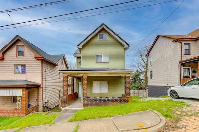 view of front of house featuring a porch, a front yard, and fence