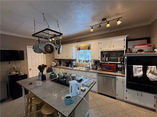 kitchen with crown molding, stainless steel dishwasher, a sink, and light tile patterned floors