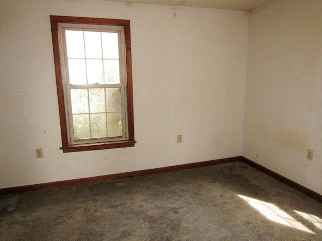empty room with baseboards and carpet flooring