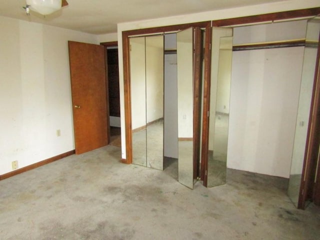 unfurnished bedroom with multiple closets