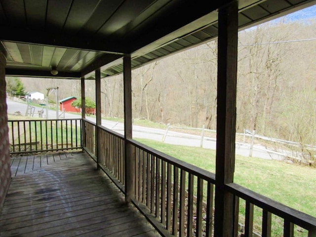 deck featuring a yard and covered porch