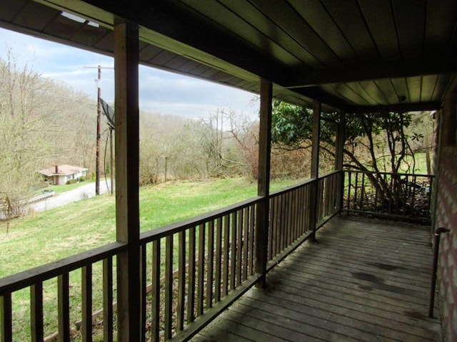 wooden terrace with a lawn