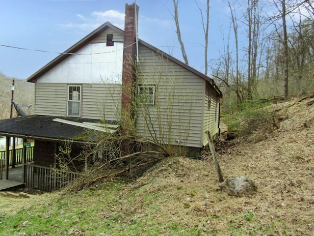 view of side of home featuring a chimney