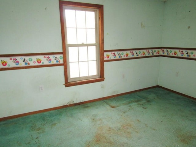 carpeted empty room with baseboards