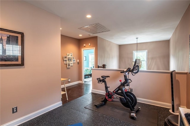 exercise room featuring baseboards, visible vents, and recessed lighting