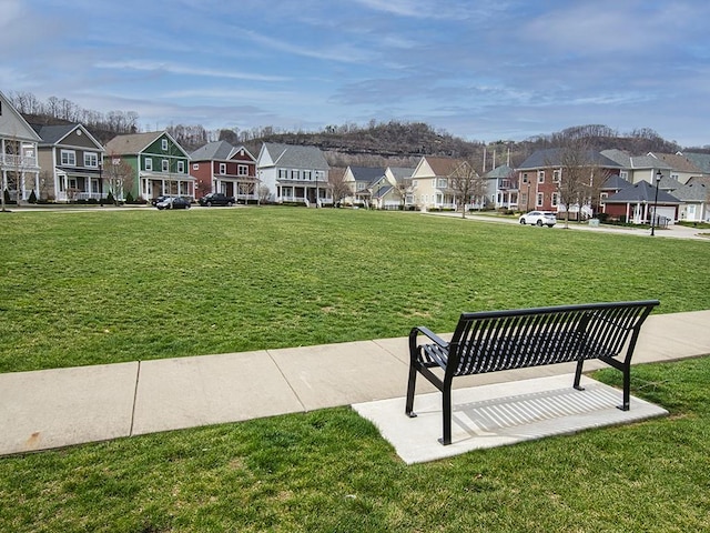 surrounding community with a residential view and a lawn