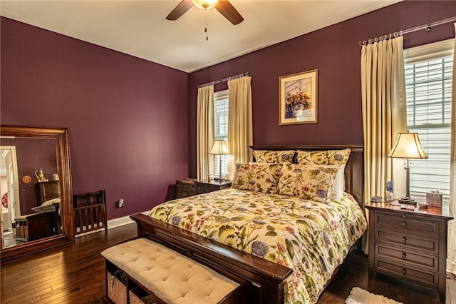 bedroom with wood-type flooring, a ceiling fan, and baseboards