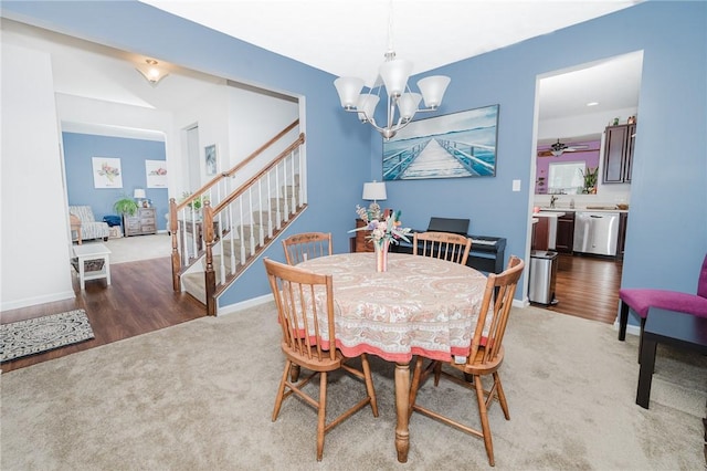 605 Skyline Ct, Irwin, PA 15642 - dining room with a notable chandelier, baseboards, light carpet, stairway, and light wood-style floors