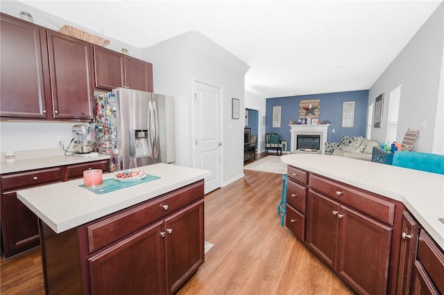 605 Skyline Ct, Irwin, PA 15642 - kitchen with light countertops, light wood-type flooring, stainless steel refrigerator with ice dispenser, and a glass covered fireplace