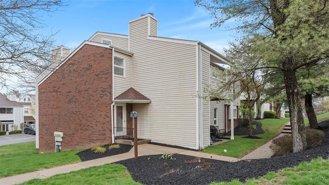 1814 Kenzie Dr, Robinson Twp Nwa, PA 15205 - view of front of home featuring a chimney, a front lawn, and brick siding