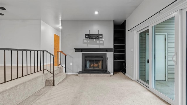 1814 Kenzie Dr, Robinson Twp Nwa, PA 15205 - unfurnished living room featuring baseboards, a ceiling fan, carpet floors, stairs, and a fireplace with raised hearth