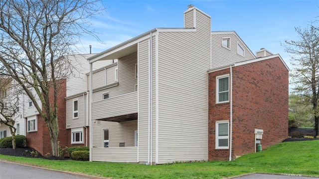 1814 Kenzie Dr, Robinson Twp Nwa, PA 15205 - view of home's exterior featuring a chimney, brick siding, and a yard