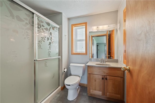 full bathroom with a shower stall, vanity, and toilet