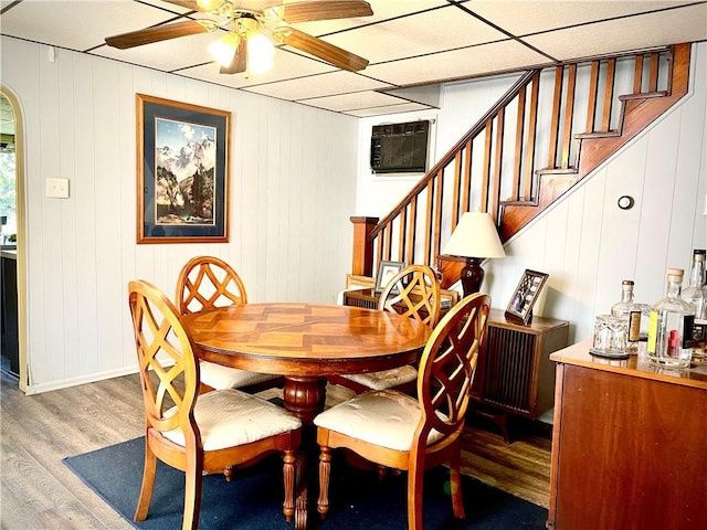 105 Ludwig St, Manorville Boro, PA 16236 - dining space featuring a wall mounted AC, a ceiling fan, stairs, and wood finished floors