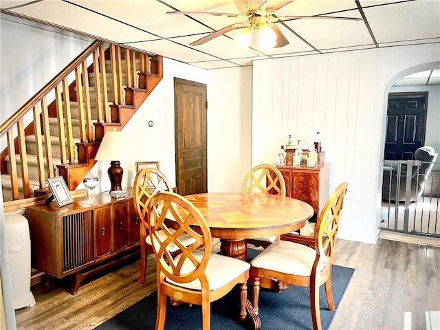 105 Ludwig St, Manorville Boro, PA 16236 - dining room featuring a ceiling fan, arched walkways, wood finished floors, and stairs