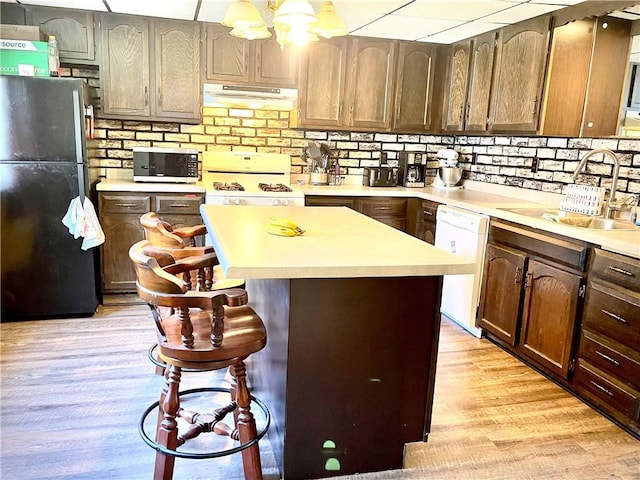 105 Ludwig St, Manorville Boro, PA 16236 - kitchen with a sink, light wood finished floors, white appliances, and under cabinet range hood