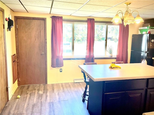 105 Ludwig St, Manorville Boro, PA 16236 - kitchen featuring light countertops, light wood finished floors, a paneled ceiling, and baseboard heating