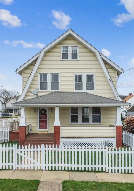 1634 Mcminn, Aliquippa, PA 15001 - view of front facade featuring roof with shingles, a porch, a gambrel roof, and a fenced front yard