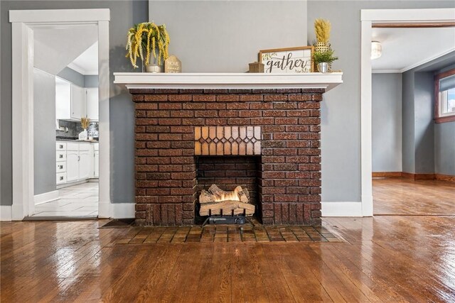 1634 Mcminn, Aliquippa, PA 15001 - room details with a brick fireplace, ornamental molding, and wood finished floors