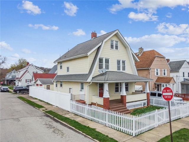 1634 Mcminn, Aliquippa, PA 15001 - back of house featuring a gambrel roof, a fenced front yard, covered porch, a shingled roof, and a residential view