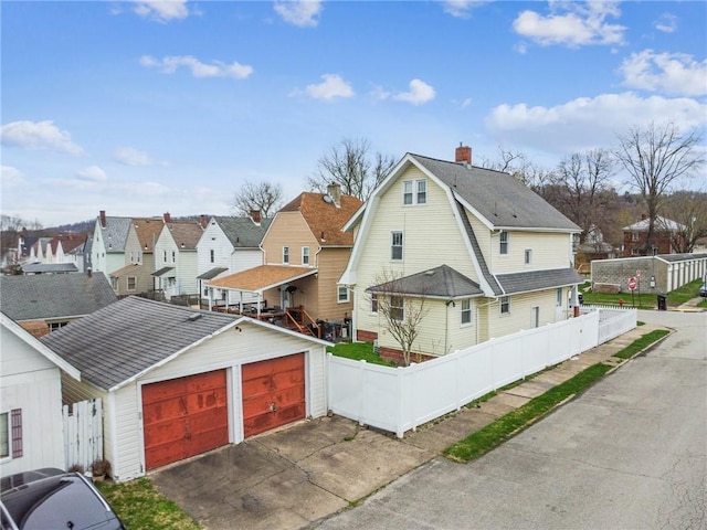 1634 Mcminn, Aliquippa, PA 15001 - view of front of house featuring a detached garage, a chimney, fence, a gambrel roof, and a residential view